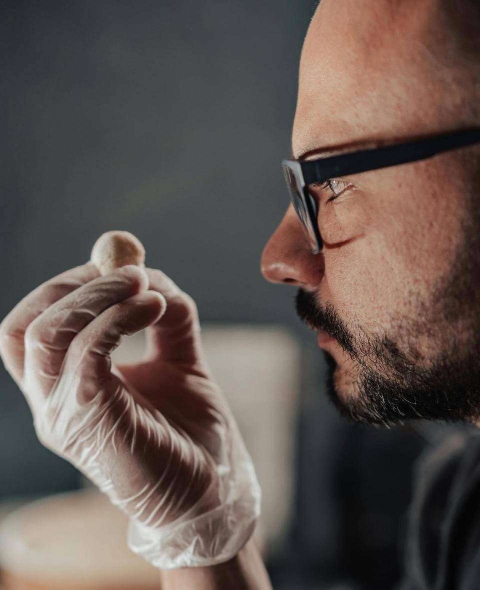 A chef examine a chocolate truffle