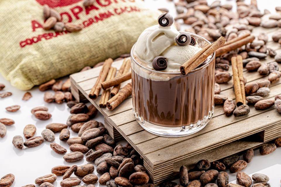 A sliced loaf of poundcake with a Ruby chocolate coating, garnished with Ruby curls and cripearls