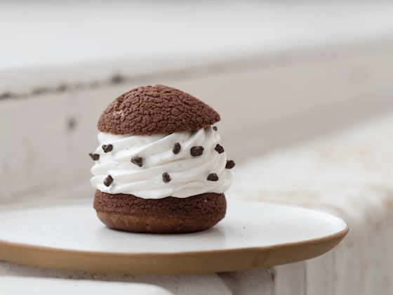 A cream-filled choux puff in natural lighting